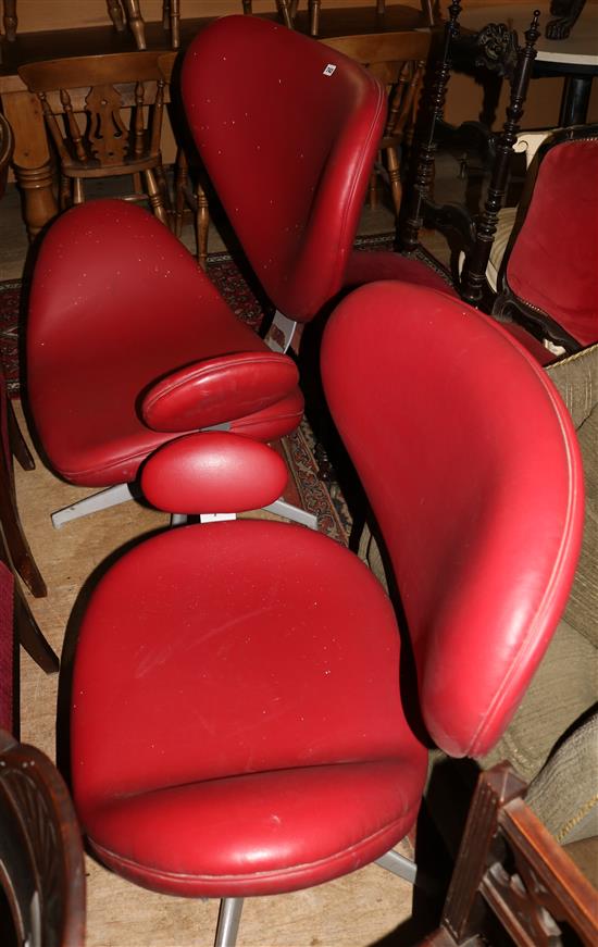 Pair of red leather swivel chairs